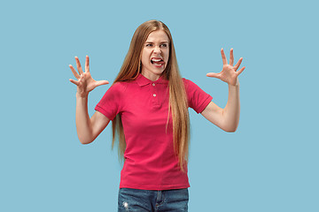 Image showing Portrait of an angry woman looking at camera isolated on a blue background