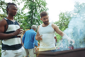 Image showing Group of friends making barbecue in the backyard. concept about good and positive mood with friends