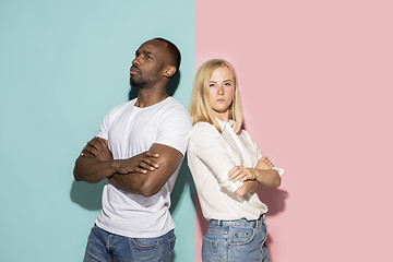 Image showing Young serious thoughtful afro man and woman at studio