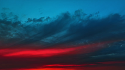 Image showing Colorful Red Glow On A Dark Cloudy Dramatic Sky