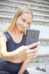 Image showing Attractive happy young woman taking selfie.