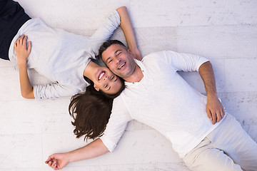 Image showing handsome couple lying on floor