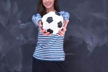 Image showing woman holding a soccer ball in front of chalk drawing board