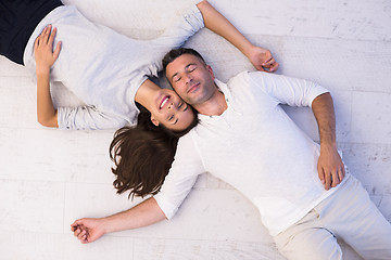 Image showing handsome couple lying on floor