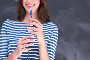 Image showing woman holding a internet cable in front of chalk drawing board