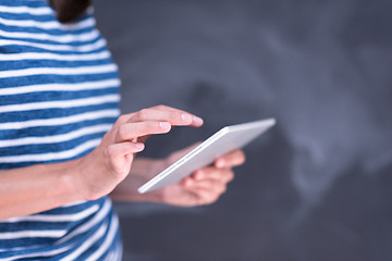 Image showing woman using tablet  in front of chalk drawing board