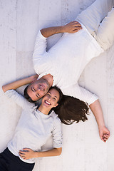 Image showing handsome couple lying on floor