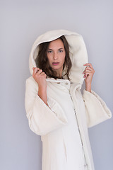 Image showing woman in a white coat with hood isolated on white background