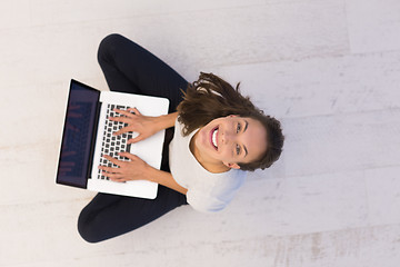 Image showing women using laptop computer on the floor top view