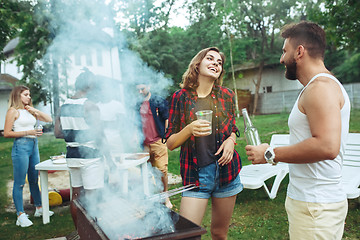 Image showing Group of friends making barbecue in the backyard. concept about good and positive mood with friends