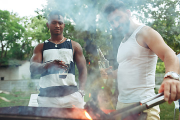 Image showing Group of friends making barbecue in the backyard. concept about good and positive mood with friends