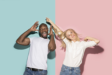 Image showing The squint eyed couple with weird expression on blue and pink studio