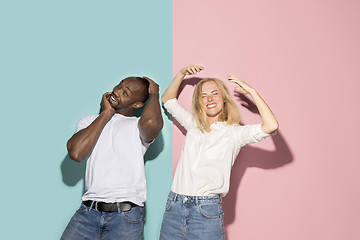 Image showing The squint eyed couple with weird expression on blue and pink studio