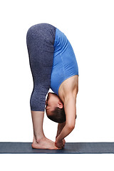 Image showing Woman doing Ashtanga Vinyasa yoga asana Padangusthasana - foot t