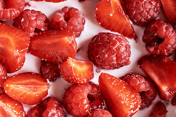 Image showing Fresh organic ripe berries with natural milk, close-up view of fruits background.