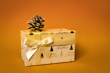 Image showing Christmas gift box on orange background
