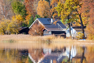 Image showing house at the lake with solar panels on the roof