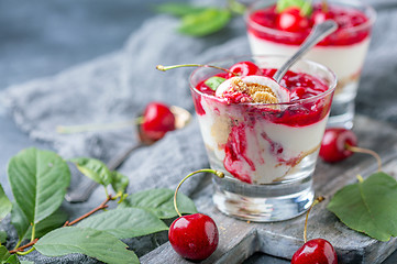 Image showing Light cheesecake with cherry jelly in a glass.
