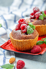 Image showing Mini tarts with raspberry, frangipani and mint.