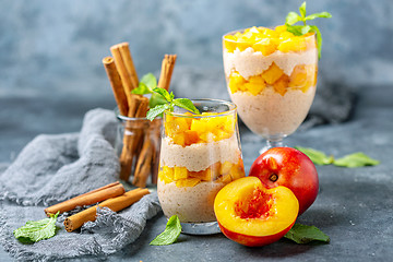 Image showing Rice pudding with pieces of nectarine in glasses.