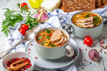 Image showing Soup with fresh cabbage and meat in ceramic bowl.