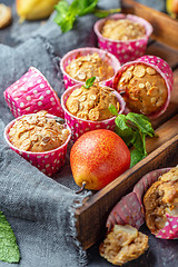 Image showing Homemade muffins with pears and muesli.