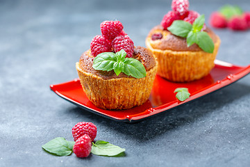 Image showing Raspberry tartlets with almond cream and mint.