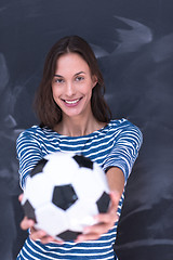 Image showing woman holding a soccer ball in front of chalk drawing board