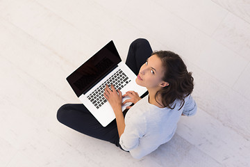 Image showing women using laptop computer on the floor top view