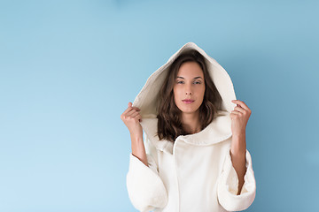 Image showing woman in a white coat with hood isolated on blue background