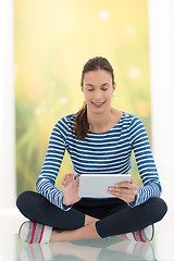 Image showing young women using tablet computer on the floor