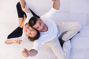 Image showing couple sitting with back to each other on floor