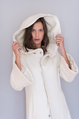 Image showing woman in a white coat with hood isolated on white background