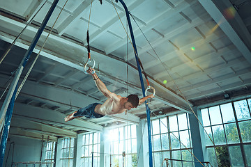 Image showing The sportsman during difficult exercise, sports gymnastics