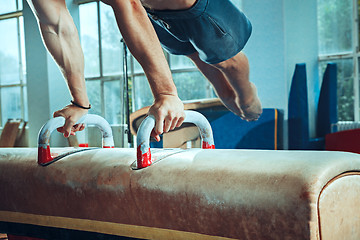 Image showing The sportsman during difficult exercise, sports gymnastics