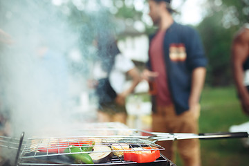 Image showing Group of friends making barbecue in the backyard. concept about good and positive mood with friends