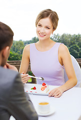 Image showing woman looking at man and eating cake at restaurant