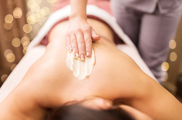 Image showing woman having back massage with cream at spa