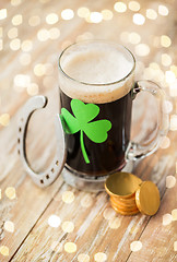 Image showing shamrock on glass of beer, horseshoe and coins