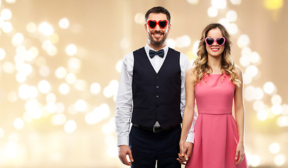 Image showing happy couple in heart-shaped sunglasses