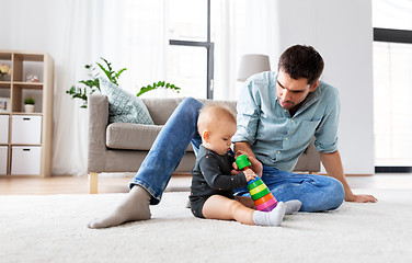 Image showing father playing with little baby daughter at home