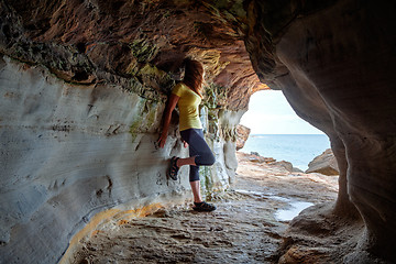 Image showing Woman standing in sandstone cave and tunnel 