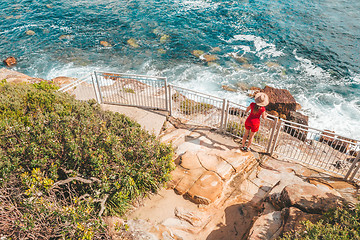 Image showing Woman at a fenced lookout over the ocean near Sydney