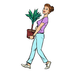 Image showing a woman carries a pot with a potted plant