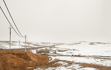 Image showing Winter field with power line columns