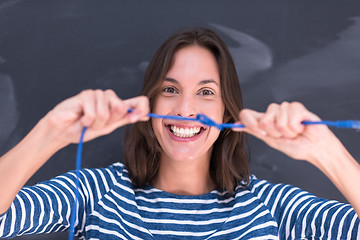 Image showing woman holding a internet cable in front of chalk drawing board