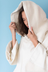 Image showing woman in a white coat with hood isolated on blue background