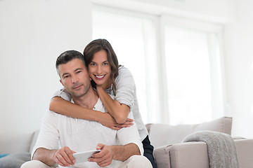 Image showing happy couple using mobile phone at home