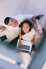 Image showing couple using tablet and laptop computers top view