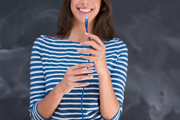 Image showing woman holding a internet cable in front of chalk drawing board